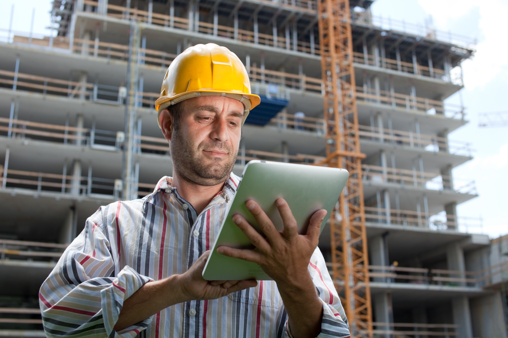 Image of tradesperson holding tablet device